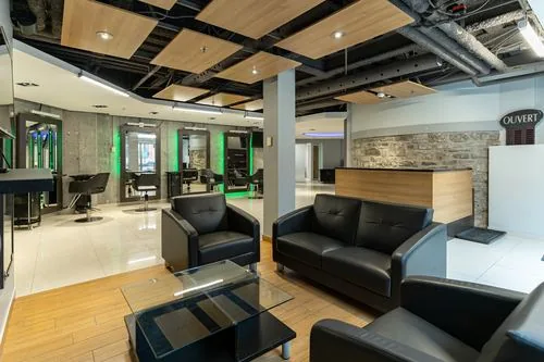 Leather seating lounge beside the reception desk and exposed stone wall