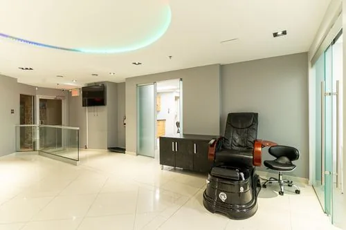Pedicure and treatment station beside the open glass stairwell