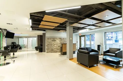 Reception and lounge with heritage stone feature wall, leather seating and street-facing windows