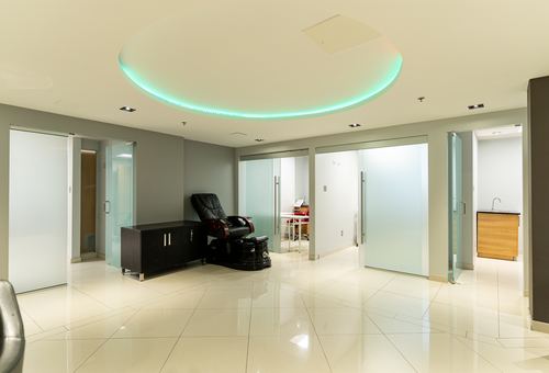 Frosted-glass private treatment rooms with adjoining kitchenette