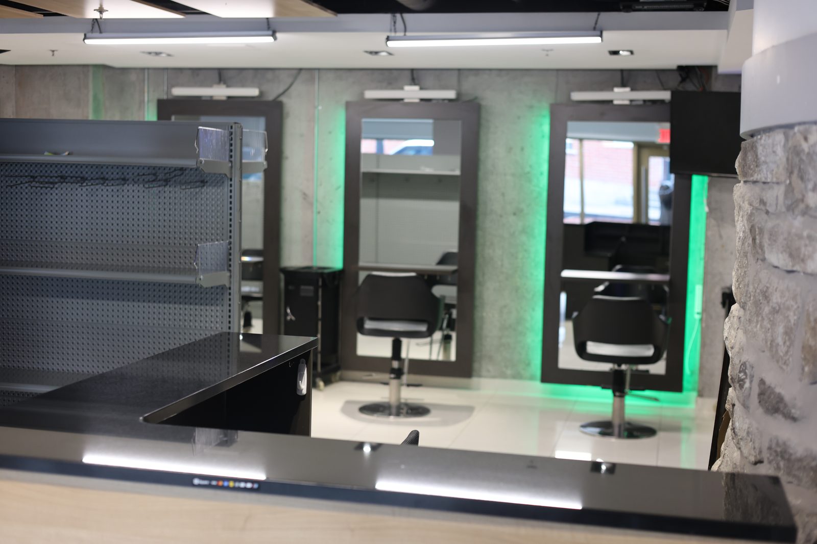 Reception area with exposed stone wall and modern finishes